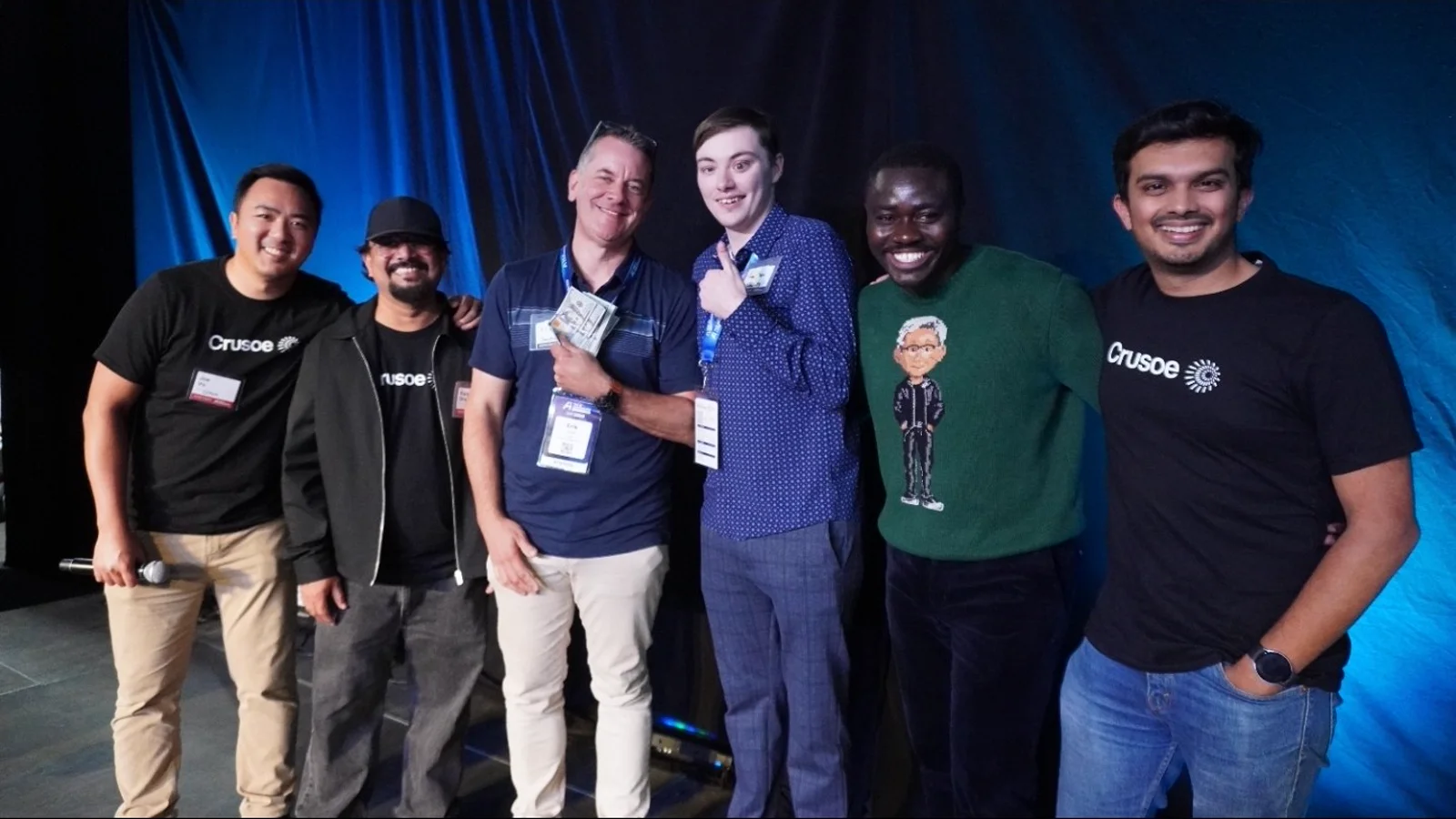 Erik Jones and Jaiven Spence on stage at The AI Conference Hack Day with the Crusoe team, Erik holding the prize